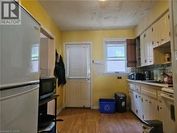 Hamilton apartment for rent - A kitchen with a white refrigerator and wooden cabinets.