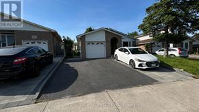 Toronto (Agincourt North) apartment for rent - A car is parked in a driveway in front of a house.