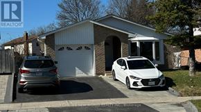 Toronto (Agincourt North) apartment for rent - A white car is parked in front of a garage.