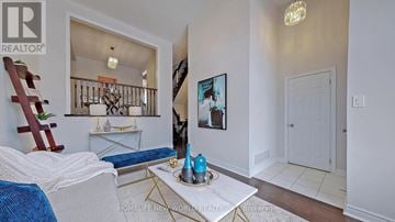 Markham (Cathedraltown) townhouse for rent - A living room with a white couch and a coffee table with a blue vase on it.