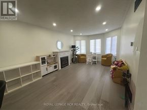 Shelburne apartment for rent - A spacious room with a fireplace and a dining table set up with chairs.