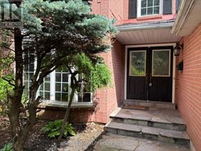 Aurora (Aurora Highlands) apartment for rent - A house with a black door and a tree in front.