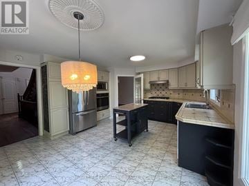 Aurora (Aurora Highlands) apartment for rent - A modern kitchen with a large island and stainless steel appliances.