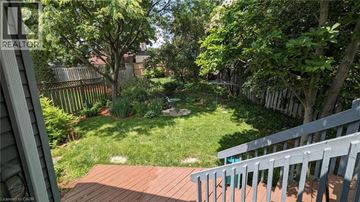 Kitchener apartment for rent - A backyard with a deck and a green lawn.