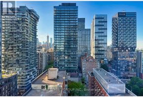 Toronto (Church-Yonge Corridor) condo for rent - A cityscape with a mix of modern and older buildings, including a building with the name "TOOR" on it.