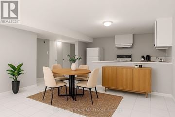 Oakville (Br Bronte) apartment for rent - A dining room with a table and chairs and a plant in a pot.