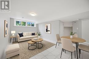 Oakville (Br Bronte) apartment for rent - A living room with a couch, chairs, and a coffee table.