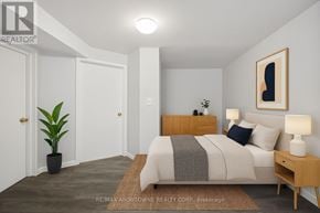 Oakville (Br Bronte) apartment for rent - A bedroom with a bed, nightstand, and lamp.