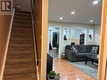 London East (East L) townhouse for rent - A living room with a couch and a staircase.