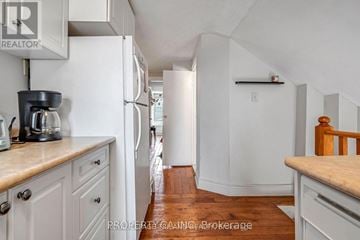 London North (North K) duplex for rent - A kitchen with white cabinets and a white refrigerator.
