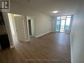 Markham (Grandview) condo for rent - A room with wooden flooring and white walls, with a door leading to a balcony.