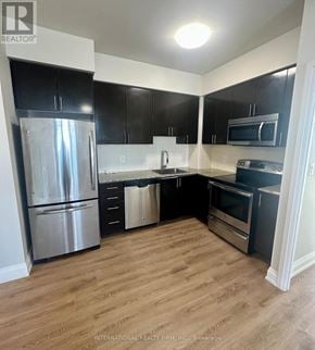 Markham (Grandview) condo for rent - A kitchen with a refrigerator, oven, and microwave.