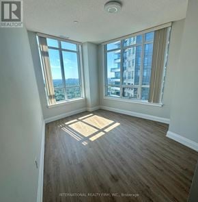 Markham (Grandview) condo for rent - A room with a large window overlooking a cityscape.