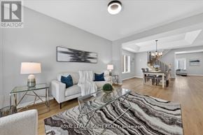 Innisfil (Alcona) apartment for rent - A well-lit, spacious living room with a glass coffee table and a white sofa.
