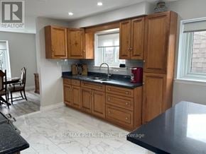 Mississauga (Cooksville) apartment for rent - A kitchen with wooden cabinets and a black countertop.