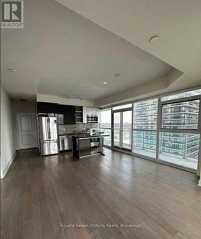 Toronto (Mimico) condo for rent - A modern kitchen with stainless steel appliances and wooden flooring.