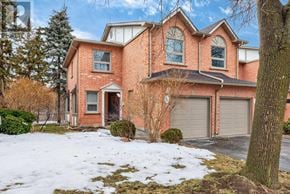 Oakville (Ro River Oaks) townhouse for rent - A large red brick house with a snow-covered front yard.