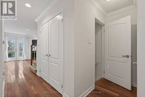 Oakville (Ro River Oaks) townhouse for rent - A hallway with white doors and wooden floors.