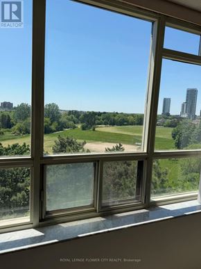 Brampton (Fletcher's Creek South) condo for rent - A window with a view of a city skyline and greenery.