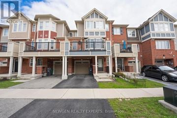 Brampton (Fletcher's West) townhouse for rent - A black car is parked in front of a brick building.