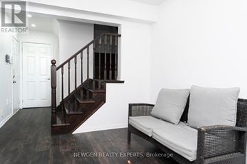 Brampton (Fletcher's West) townhouse for rent - A living room with a couch and a staircase.