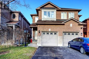 Mississauga (East Credit) apartment for rent - A house with a blue car parked in front of it.