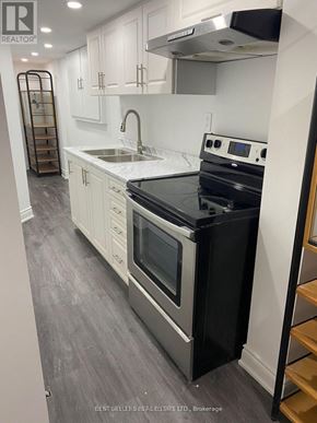 Mississauga (East Credit) apartment for rent - A modern kitchen with a black stove top oven.