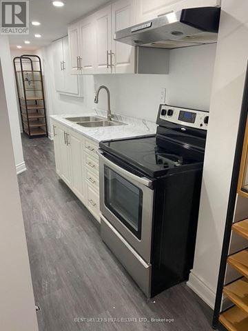 Mississauga (East Credit) apartment for rent - A modern kitchen with a black stove top oven.