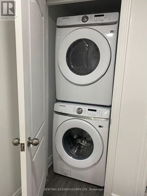 Mississauga (East Credit) apartment for rent - Two white front load washing machines in a small closet.