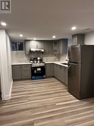 Brampton (Brampton East) apartment for rent - A kitchen with wooden flooring and stainless steel appliances.