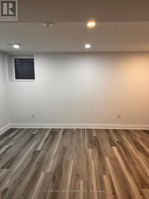 Brampton (Brampton East) apartment for rent - A room with wooden flooring and a window.