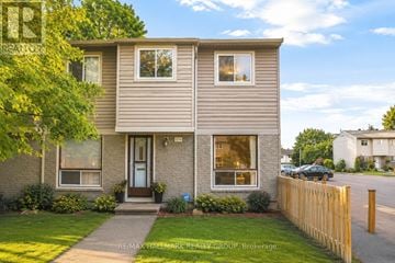 Ottawa townhouse for rent - A two-story house with a brown door and windows.