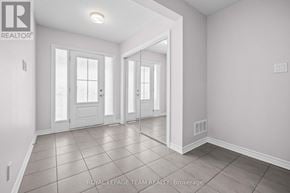 Ottawa townhouse for rent - A spacious room with white walls and a tiled floor.