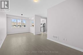 Ottawa townhouse for rent - A spacious room with a large window and a door leading to another room.