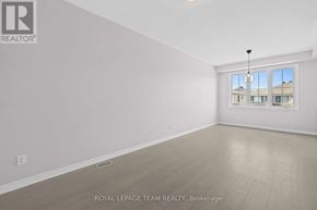 Ottawa townhouse for rent - A white room with a window and a sign that says "Royal LePage Team Realty, Brokerage".