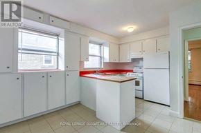 Toronto (Bedford Park-Nortown) apartment for rent - A kitchen with white cabinets and a red counter.