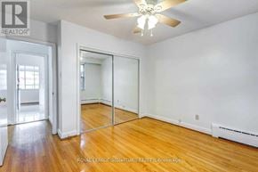 Toronto (Bedford Park-Nortown) apartment for rent - A room with a ceiling fan and wooden floors.