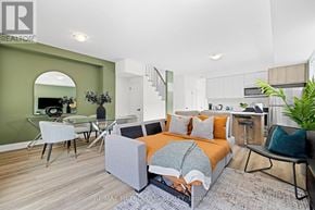 Toronto (Dufferin Grove) fourplex for rent - A bedroom with a bed, chair, and a mirror.