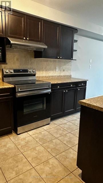 Ajax (Northwest Ajax) townhouse for rent - A kitchen with dark brown cabinets and a stainless steel range hood.