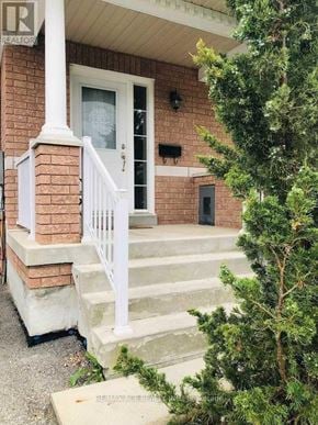 Ajax (Northwest Ajax) townhouse for rent - A house with a white door and steps leading up to it.