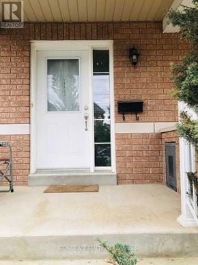 Ajax (Northwest Ajax) townhouse for rent - A white door with a glass window is on a brick wall.