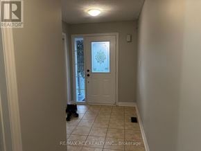 Ajax (Northwest Ajax) townhouse for rent - A hallway with a door and a person standing in front of it.