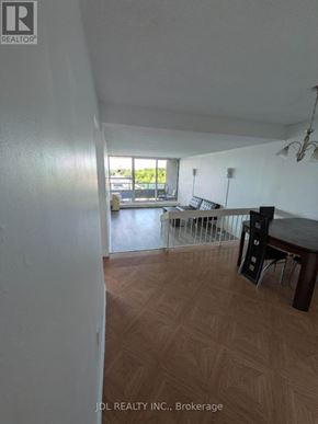 Toronto (Agincourt South-Malvern West) condo for rent - A room with a wooden floor and a table with chairs.