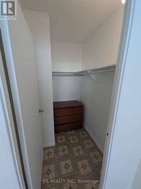 Toronto (Agincourt South-Malvern West) condo for rent - A hallway with a tiled floor and a bench under a window.