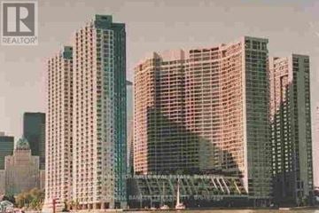 Toronto (Waterfront Communities) condo for rent - A cityscape with skyscrapers and a bridge in the background.