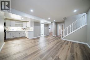 Brantford apartment for rent - A spacious open plan kitchen and living room with wooden flooring.