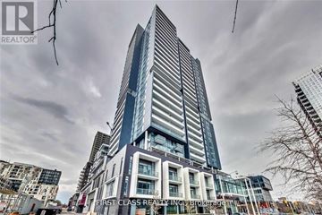 Toronto (Regent Park) condo for rent - A tall building with a glass facade is under construction.