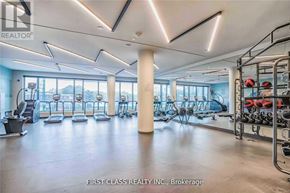 Toronto (Regent Park) condo for rent - A gym with a variety of equipment including treadmills, weights, and exercise machines.