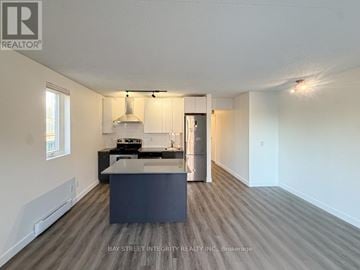 Toronto (South Riverdale) apartment for rent - A spacious kitchen with a large island in the middle.