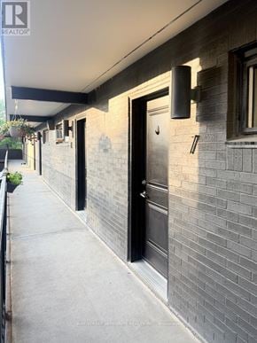 Toronto (South Riverdale) apartment for rent - A building with a black door and a window with a white frame.